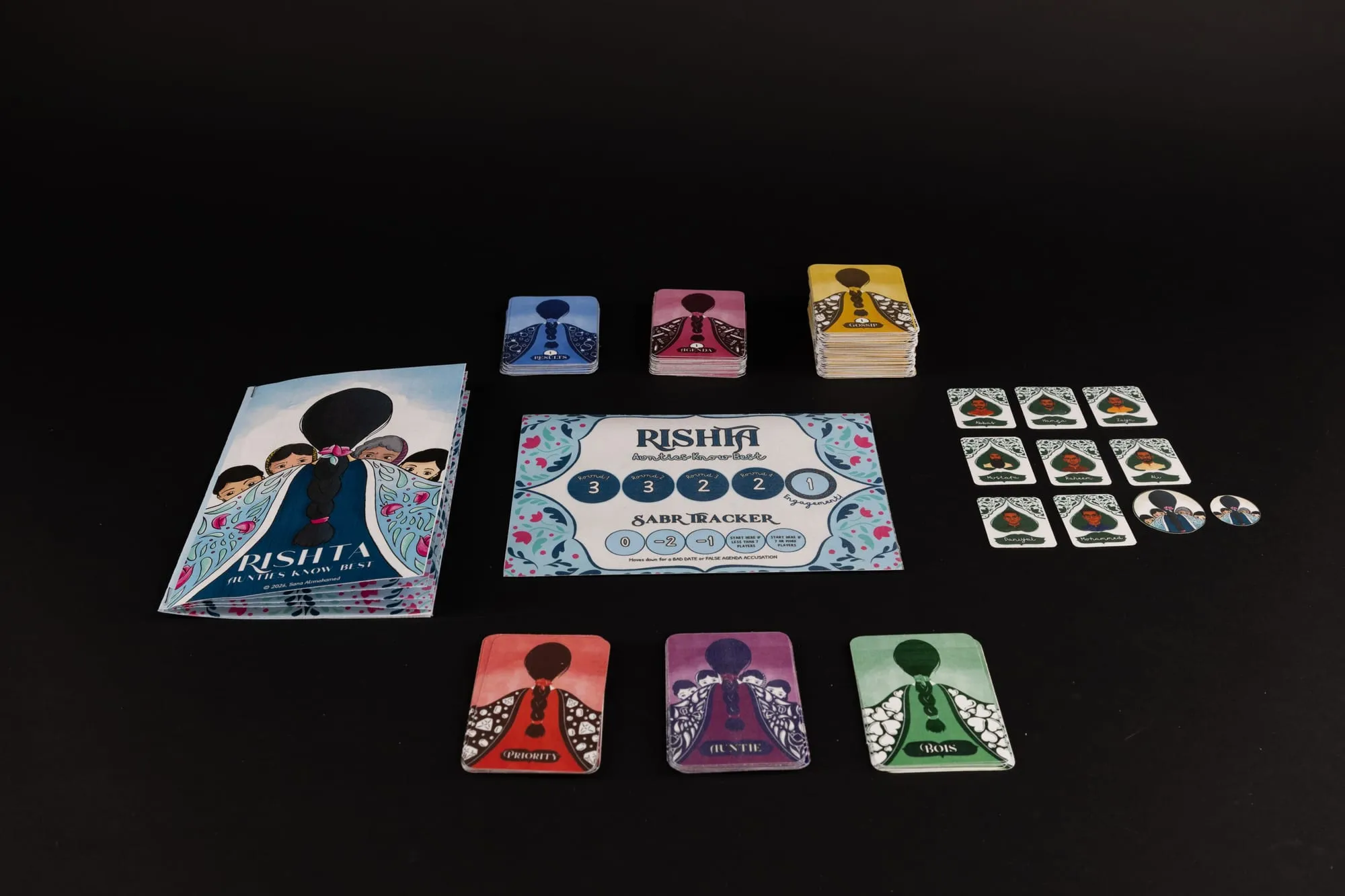 The full Rishta set on black — box, board, suitor cards, tokens and card stacks