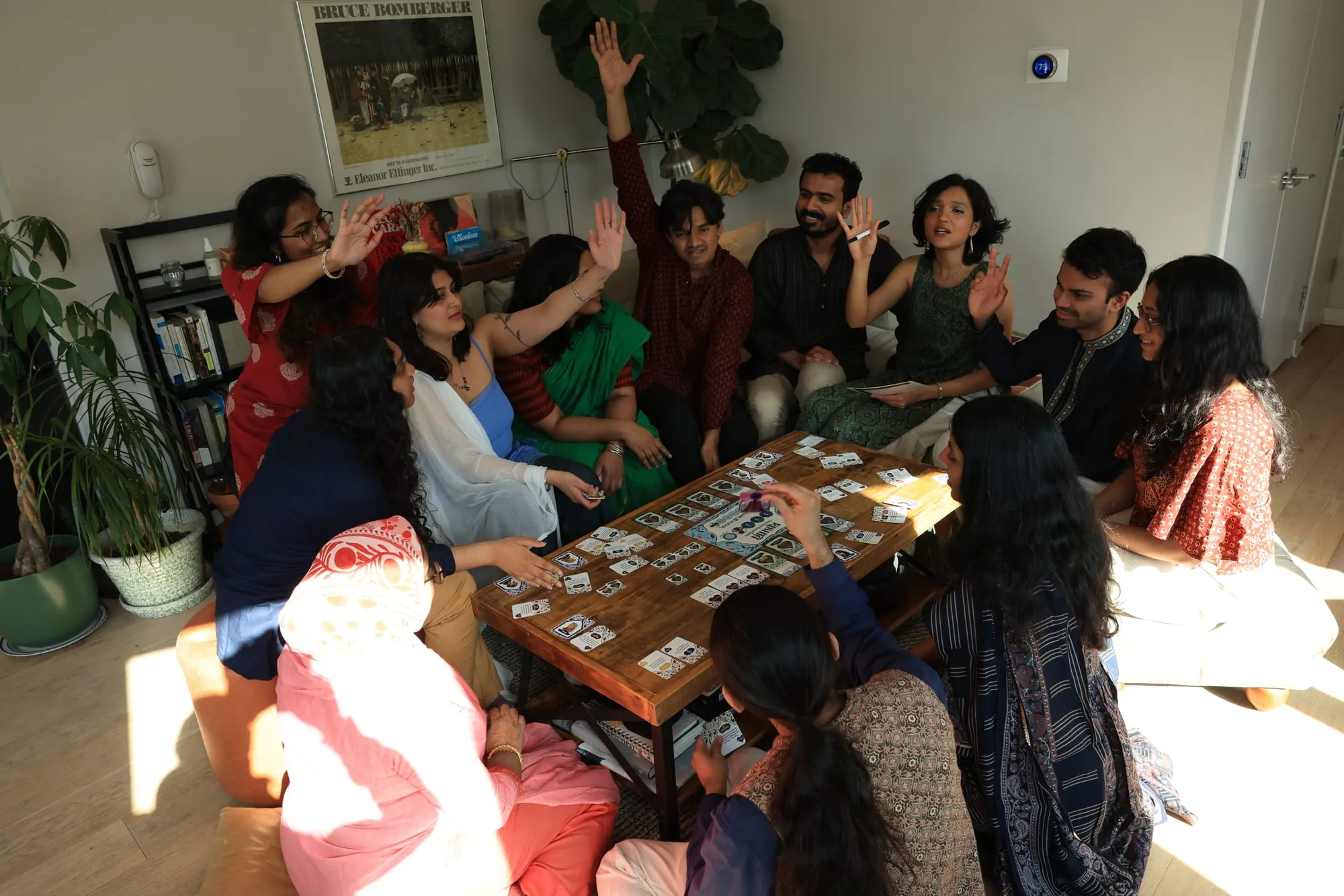 The whole group with hands in the air, voting on the engagement
